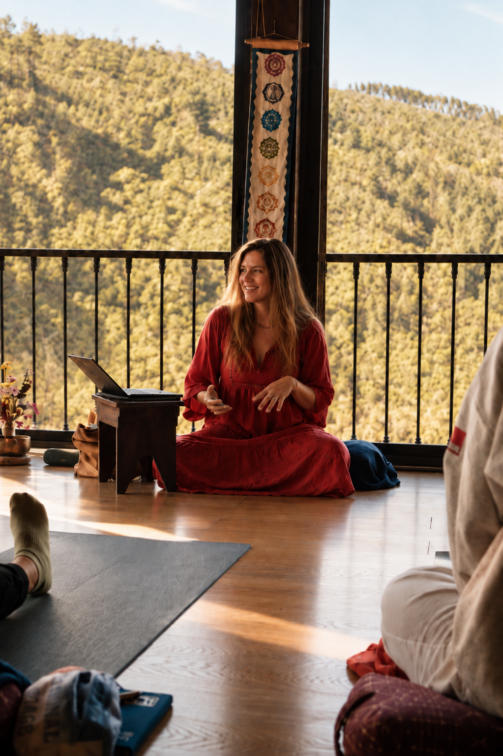 Naianna leading a small group session in a sunlit mountain studio