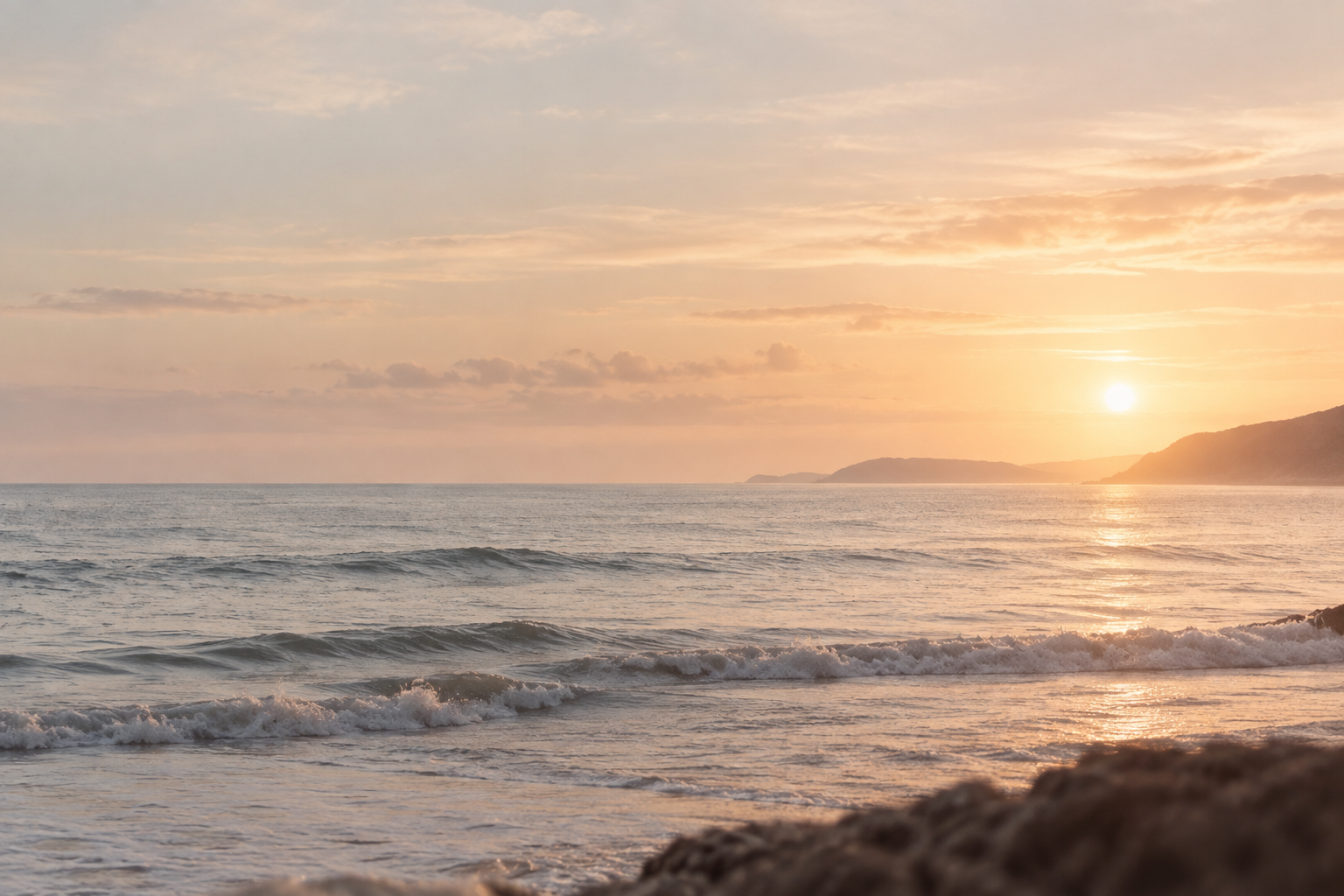 Sunset over the sea and distant coastline
